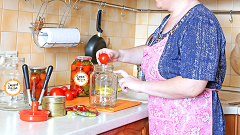 a grandma canning tomatoes in her kitchen