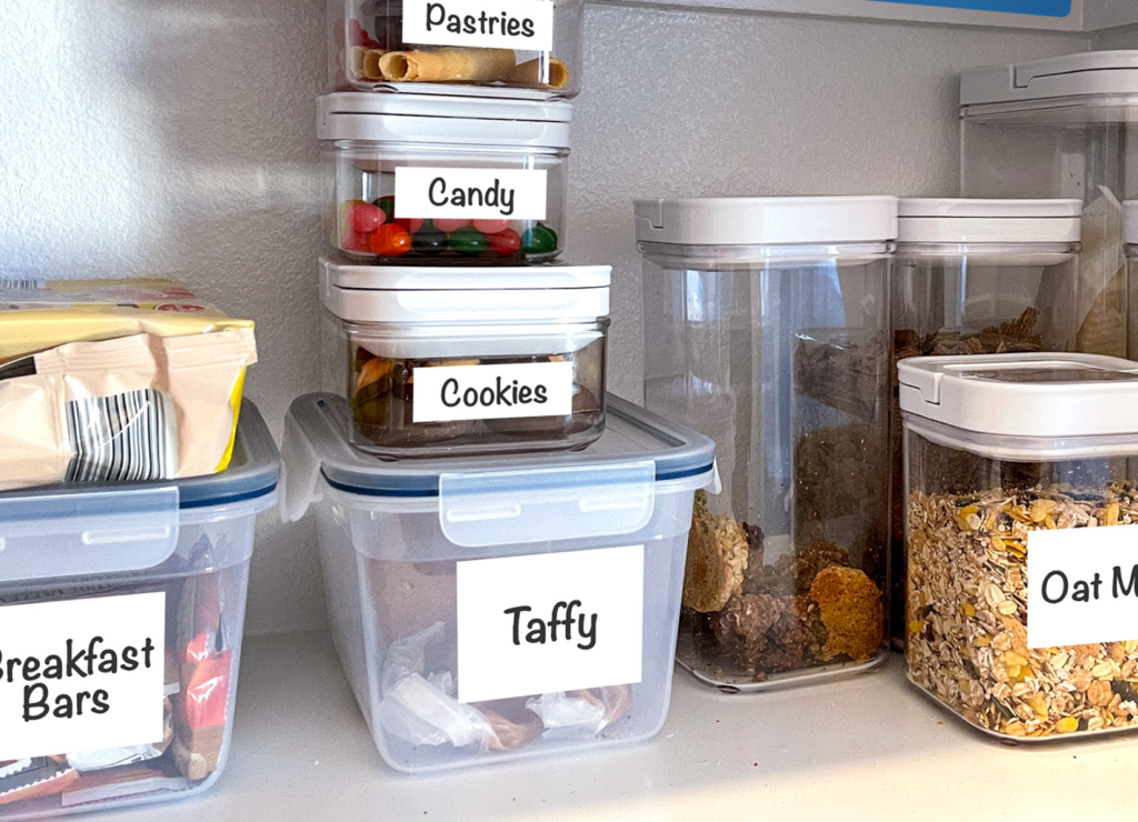 storage bin containers that are labeled in a pantry