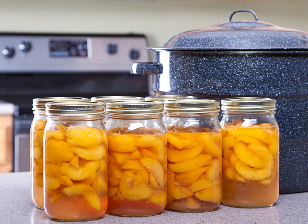 jars of peaches on a kitchen counter