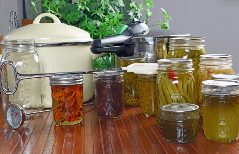 canning jars and canning supplies on a kitchen counter